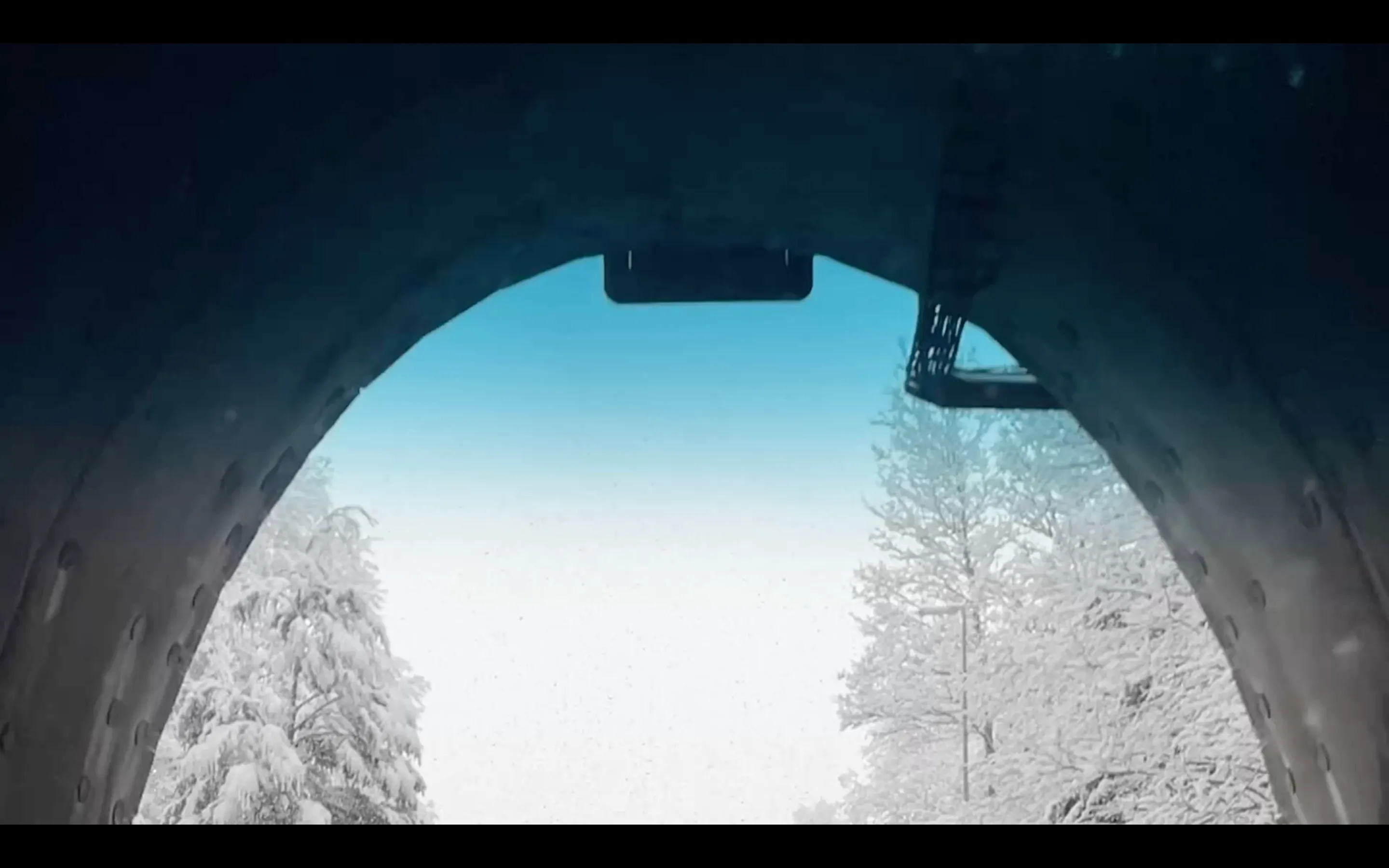 Las Raices tunnel exit revealing snowy Araucanía landscape with Lonquimay and Sierra Nevada mountains