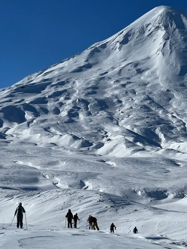 A group skinning up towards the Llaima volcano